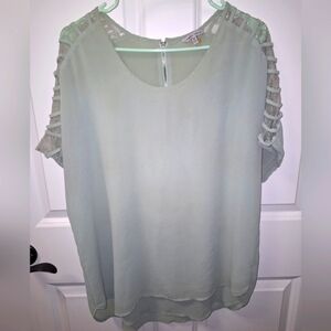 A Naked Zebra short sleeve ladies top in a size 1X. It features sheer shoulders